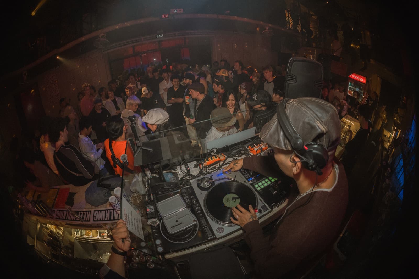 A DJ playing vinyl to a full room at Airtime Asia