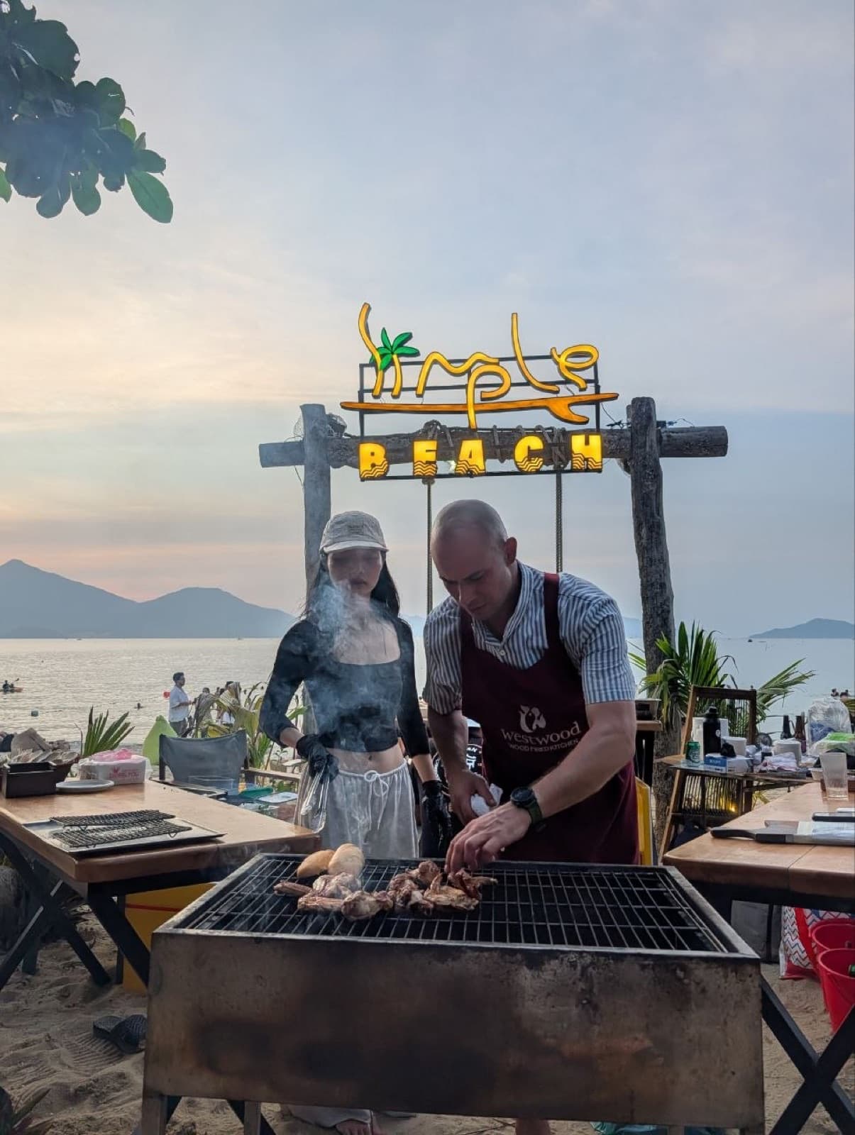 A beach party with a fire at Airtime Asia