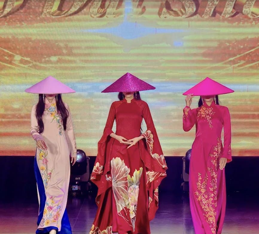 Ao Dai Show, three performers in pink and red ao dai with matching conical hats