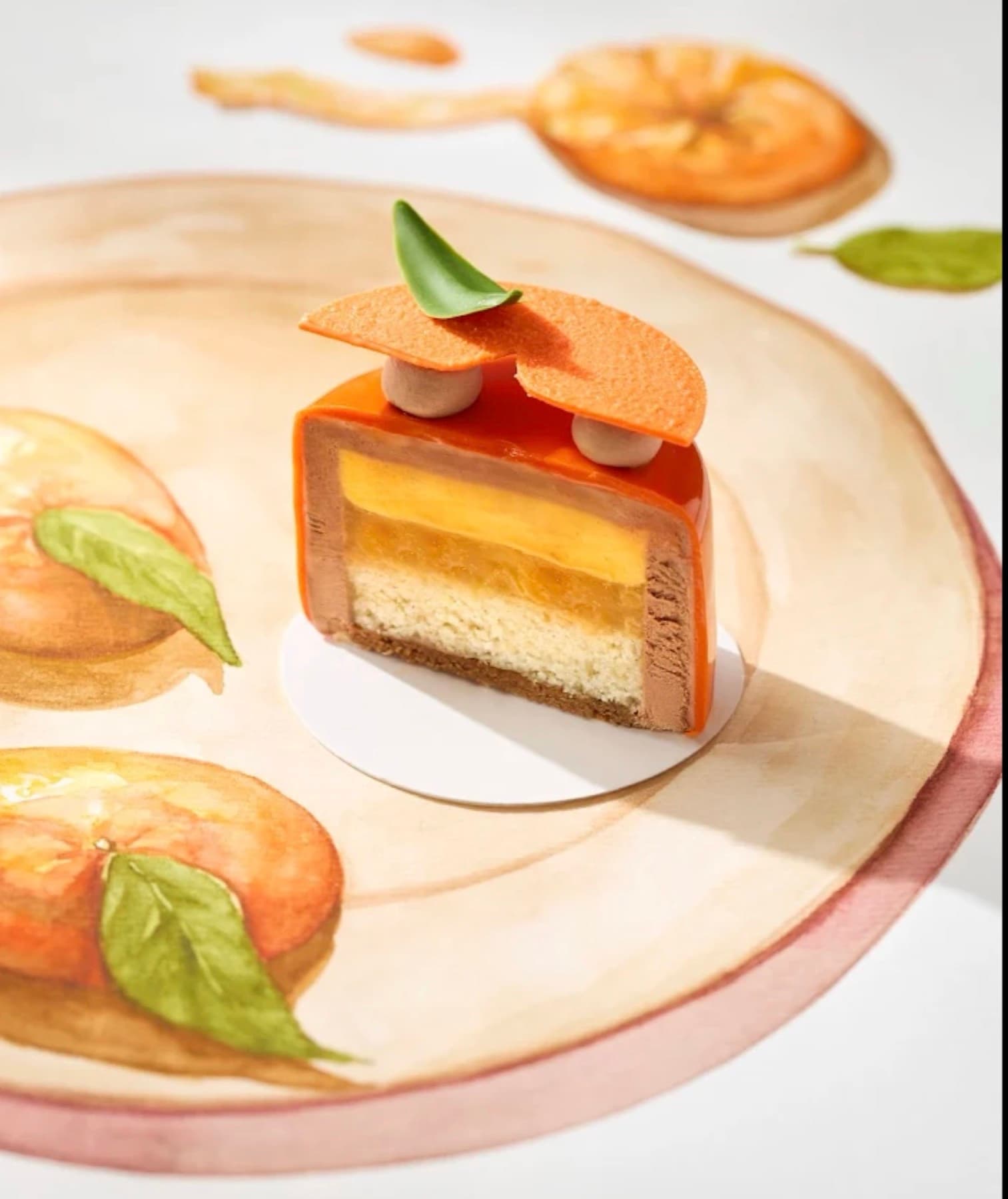 Bloom, a layered entremet cut open to show the mousse and sponge