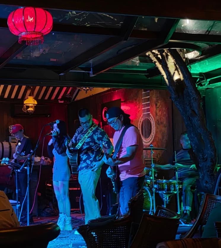 C Bar, a band playing on the stage under a red lantern