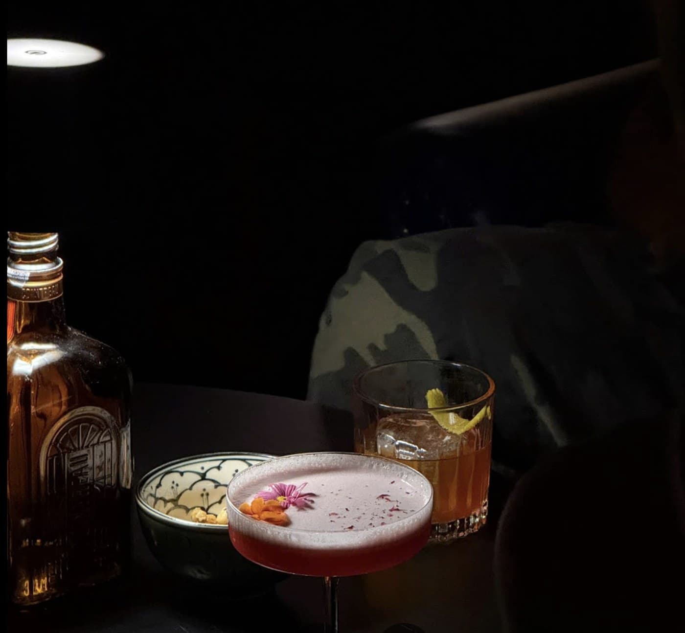 ĐÊM Speakeasy, two drinks on a dark table