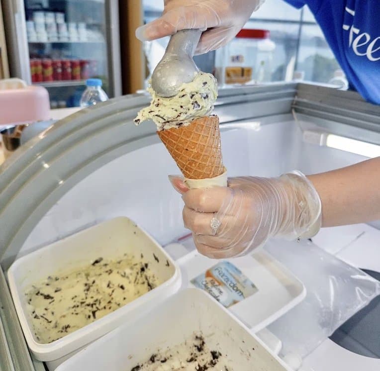 A scoop of handmade gelato going onto a cone at Freezedom
