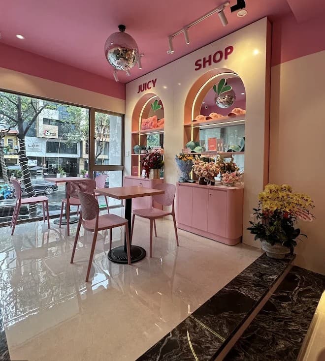 The Juicy Shop corner at GetJuicy Health Bar, with arched shelves, pink chairs and a mirror ball