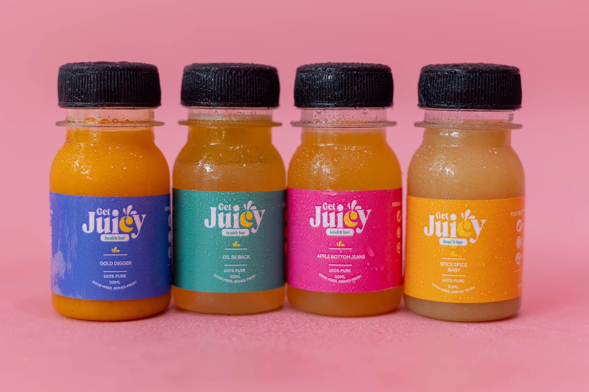 The four GetJuicy Health Bar shots in a row on a pink background