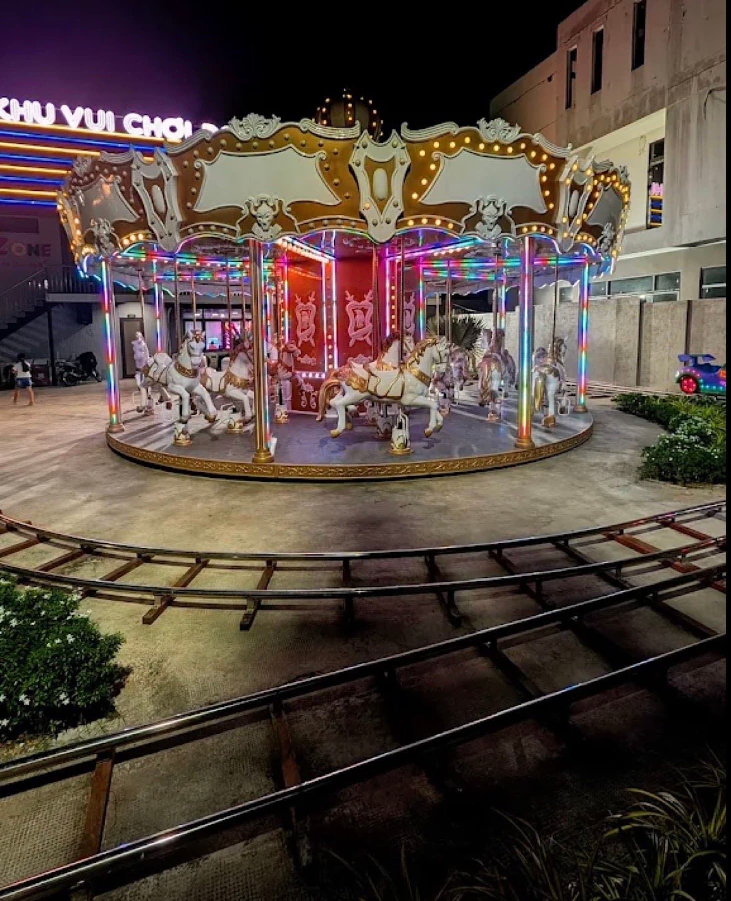 Go Kart Da Phuoc, a carousel lit up at night beside a small train track