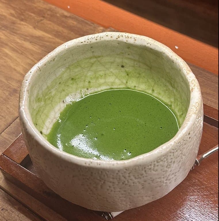 Matcha whisked in a handmade speckled bowl at SẾU the tearoom