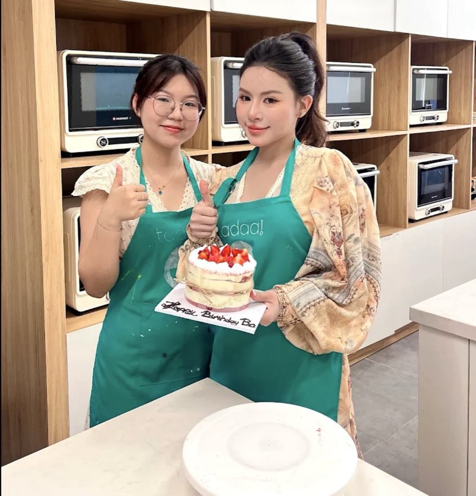 A class at Tadaa, holding the cake they just made in Da Nang